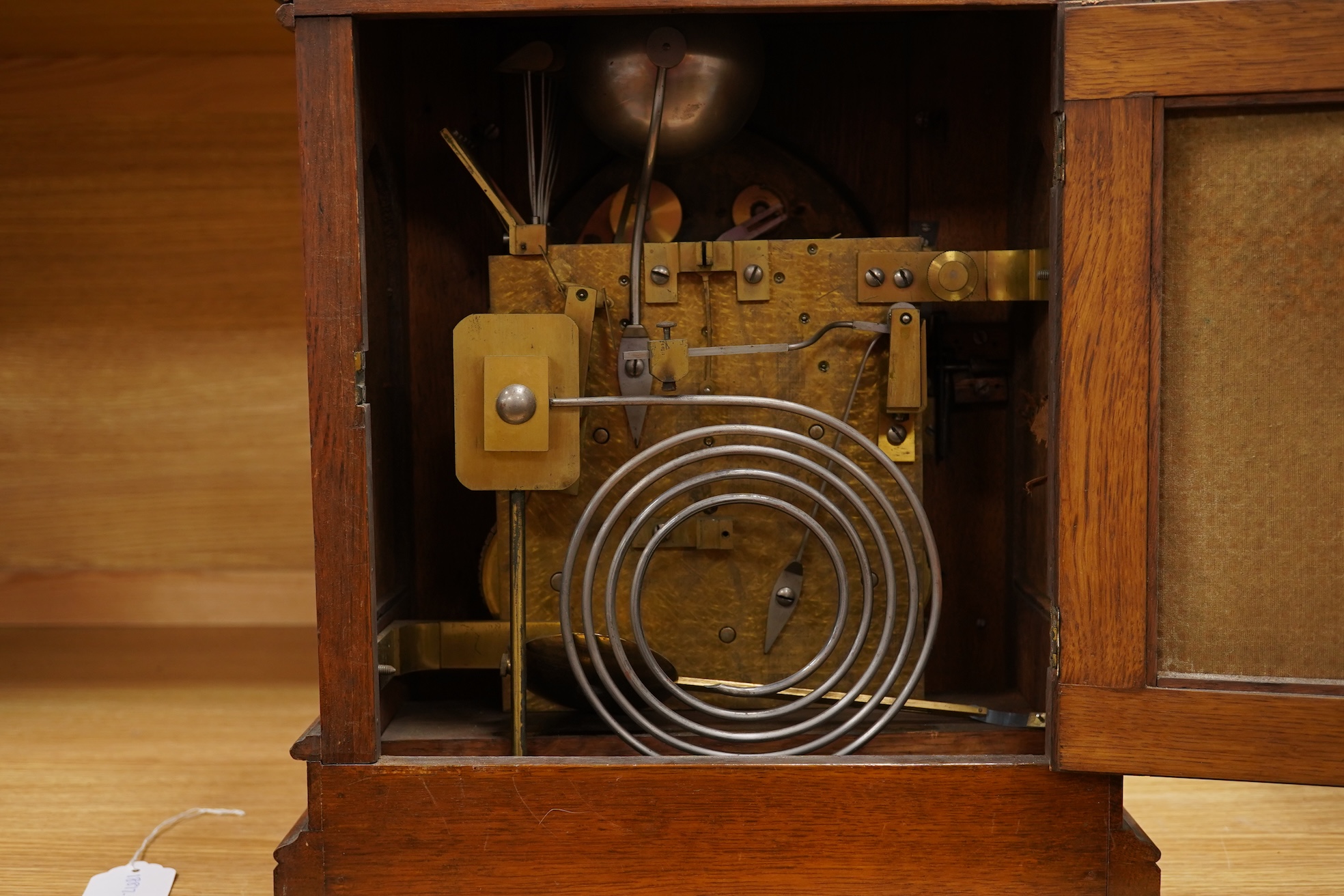 A German Gothic style oak mantel clock, early 20th century, with pendulum and keys, 49cm high